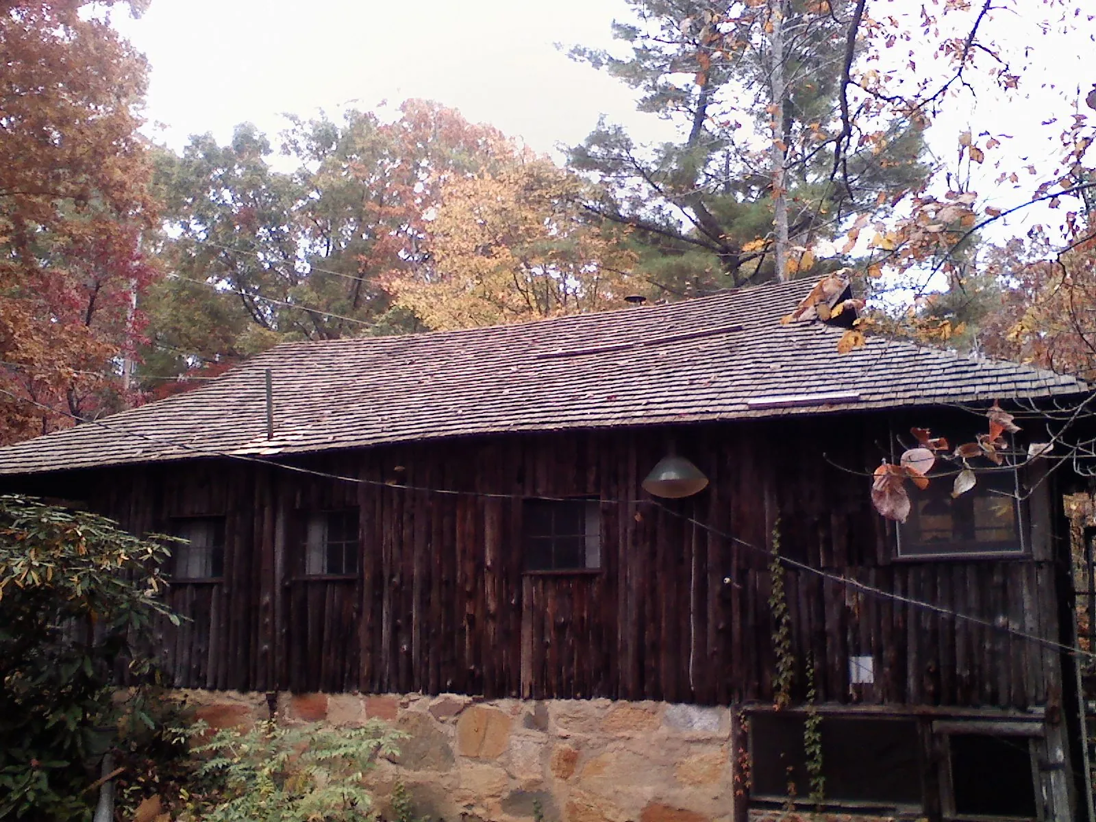 Weathered wood shake roof on a rustic board sided cabin in Bettendorf